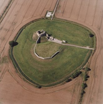 Oblique aerial view centred on the remains of the motte and castle, taken from the SE.