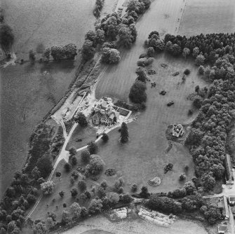 Oblique aerial view centred on the country house during renovation and the remains of the laundry, taken from the NNW.
