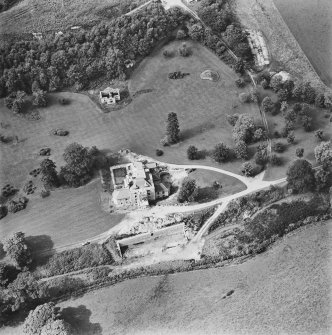 Oblique aerial view centred on the country house during renovation and the remains of the laundry, taken from the ESE.