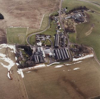 Oblique aerial view centred on the whisky distillery, taken from the WNW.