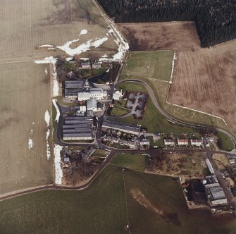 Oblique aerial view centred on the whisky distillery, taken from the SSW.