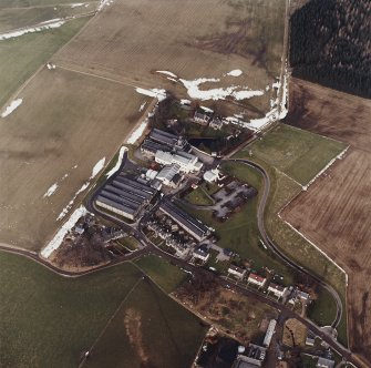Oblique aerial view centred on the whisky distillery, taken from the S.