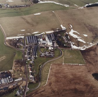 Oblique aerial view centred on the whisky distillery, taken from the SE.