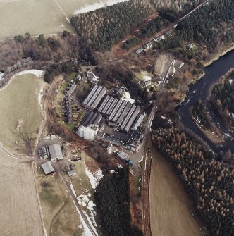 Oblique aerial view centred on the whisky distillery, taken from the W.