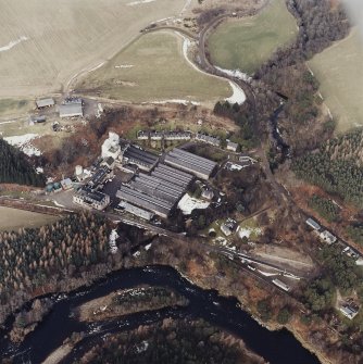 Oblique aerial view centred on the whisky distillery, taken from the SSE.