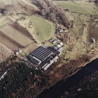 Oblique aerial view centred on the whisky distillery, taken from the W.