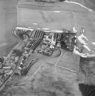 Oblique aerial view centred on the whisky distillery, taken from the ESE.
