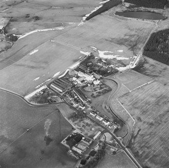 Oblique aerial view centred on the whisky distillery, taken from the SSE.