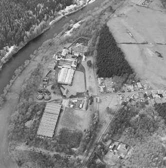Oblique aerial view centred on the whisky distillery, taken from the E.