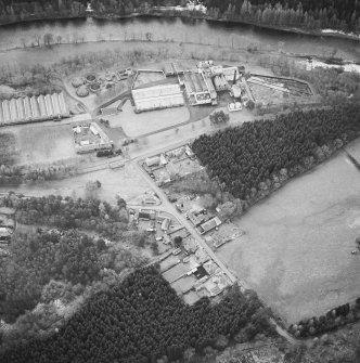 Oblique aerial view centred on the whisky distillery, taken from the NE.