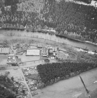 Oblique aerial view centred on the whisky distillery, taken from the N.