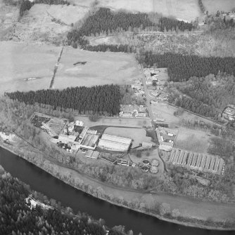 Oblique aerial view centred on the whisky distillery, taken from the S.