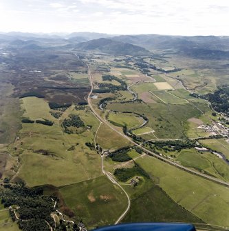 General oblique aerial view looking over the Ruthven Barracks towards Newtonmore, taken from the E.