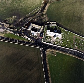 Oblique aerial view of the church, churchyard and farmstead, taken from the SSE.