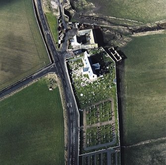Oblique aerial view of the church, churchyard and farmstead, taken from the E.