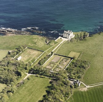 Aerial view of Dunbeath Castle and walled gardens from SW.