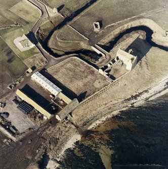 Oblique aerial view of the castle, bridge, farmsteading and the remains of the mausoleum, dovecot and anti-tank blocks, taken from the E.