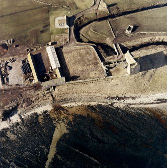 Oblique aerial view of the castle, bridge, farmsteading and the remains of the mausoleum, dovecot and anti-tank blocks, taken from the NE.