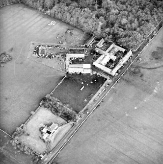 Oblique aerial view centred on the farmsteading, taken from the W