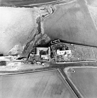 Oblique aerial view of the church, churchyard and farmstead, taken from the S.