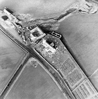 Oblique aerial view of the church, churchyard and farmstead, taken from the SE.