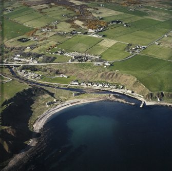 General oblique aerial view of Dunbeath centred on the harbour, taken from the S.