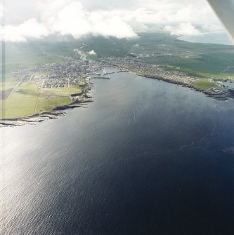 General oblique aerial view of the town and harbour, taken from the SE.