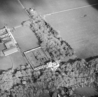 Oblique aerial view centred on the country house and walled garden with the farmsteading adjacent, taken from the WNW.