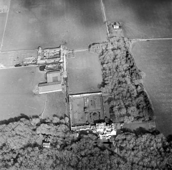 Oblique aerial view centred on the country house and walled garden with the farmsteading adjacent, taken from the W.