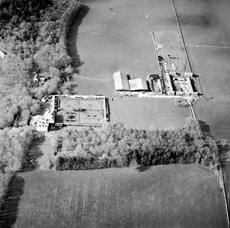 Oblique aerial view centred on the country house and walled garden with the farmsteading adjacent, taken from the S.