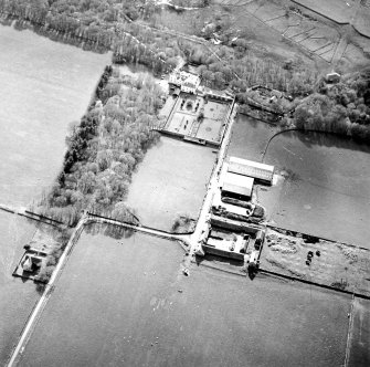 Oblique aerial view centred on the country house and walled garden with the farmsteading adjacent, taken from the ENE.