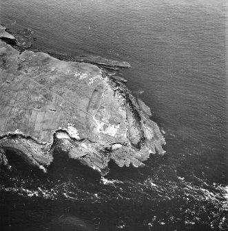 Stroma, oblique aerial view, taken from the E, centred on the lighthouse, and showing the edge of Nethertown township in the left centre of the photograph, and Bught o' Camm promotory fort in the top left-hand corner.