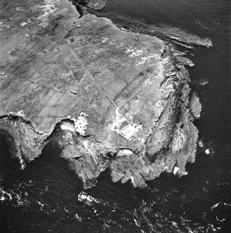 Stroma, oblique aerial view, taken from the NE, centred on the lighthouse, and showing the edge of Nethertown township in the left half of the photograph.