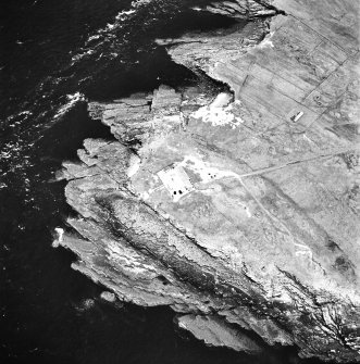 Stroma, oblique aerial view, taken from the NW, centred on the lighthouse, and showing the edge of Nethertown township in the centre right of the photograph.