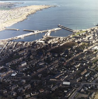 Oblique aerial view centred on the harbour with the town adjacent, taken from the W.