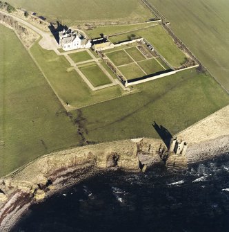 Oblique aerial view of the country house, walled garden and the remains of the castle and memorial, taken from the SSE.