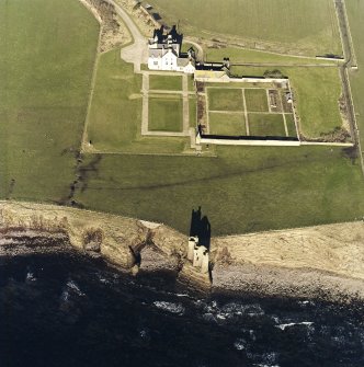Oblique aerial view of the country house, walled garden and the remains of the castle and memorial, taken from the SE.