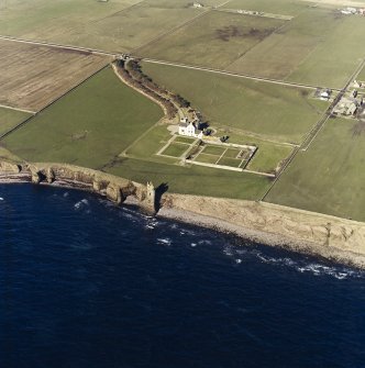 Oblique aerial view of the country house, walled garden, lodge and the remains of the castle, and memorial, taken from the E.