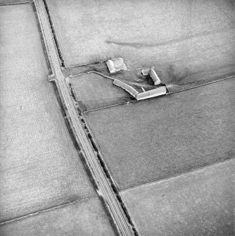 Oblique aerial view centred on the farmsteading, taken from the NNW.