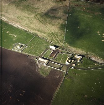 Oblique aerial view centred on the farmstead and mausoleum, taken from the ENE.