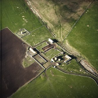 Oblique aerial view centred on the farmstead and mausoleum, taken from the NE.