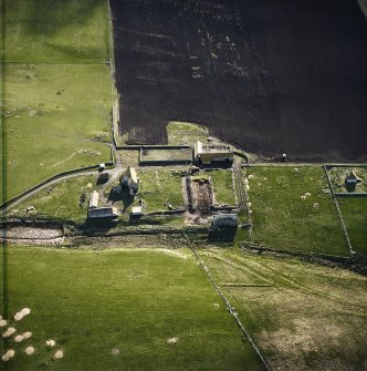 Oblique aerial view centred on the farmstead and mausoleum, taken from the W.
