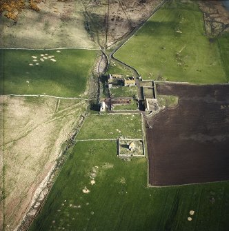 Oblique aerial view centred on the farmstead and mausoleum, taken from the S.
