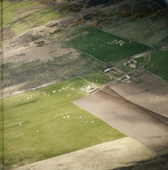 Oblique aerial view centred on the farmsteading and mausoleum, taken from the SE.