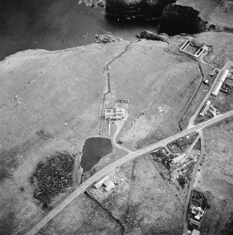Oblique aerial view centred on the watermill with the house, curing yard, farmsteads and council houses adjacent, taken from the NNW.