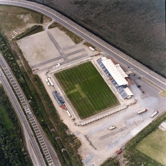 Oblique aerial view centred on the football stadium, taken from the S.