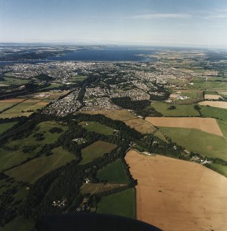 General oblique aerial view looking across the Caledonian Canal and Inverness towards the road bridge and the Moray Firth, taken from the S.