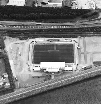 Oblique aerial view centred on the football stadium, taken from the NE.
