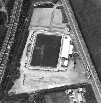 Oblique aerial view centred on the football stadium, taken from the SE.