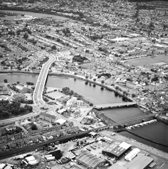 General oblique aerial view of the town, centred on the road bridges and school, taken from the NE.